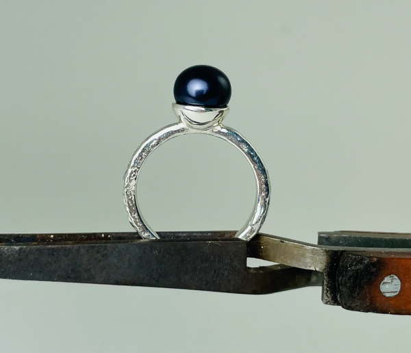 Silver ring with dark purple pearl