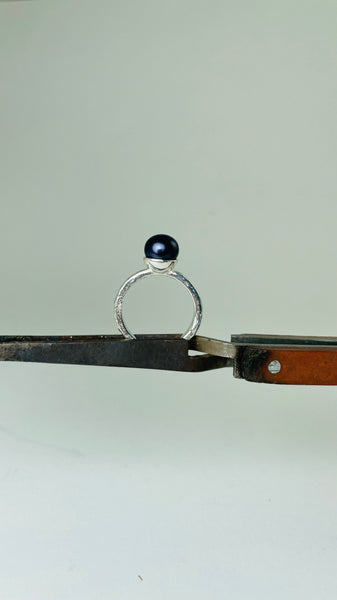 Silver ring with dark purple pearl