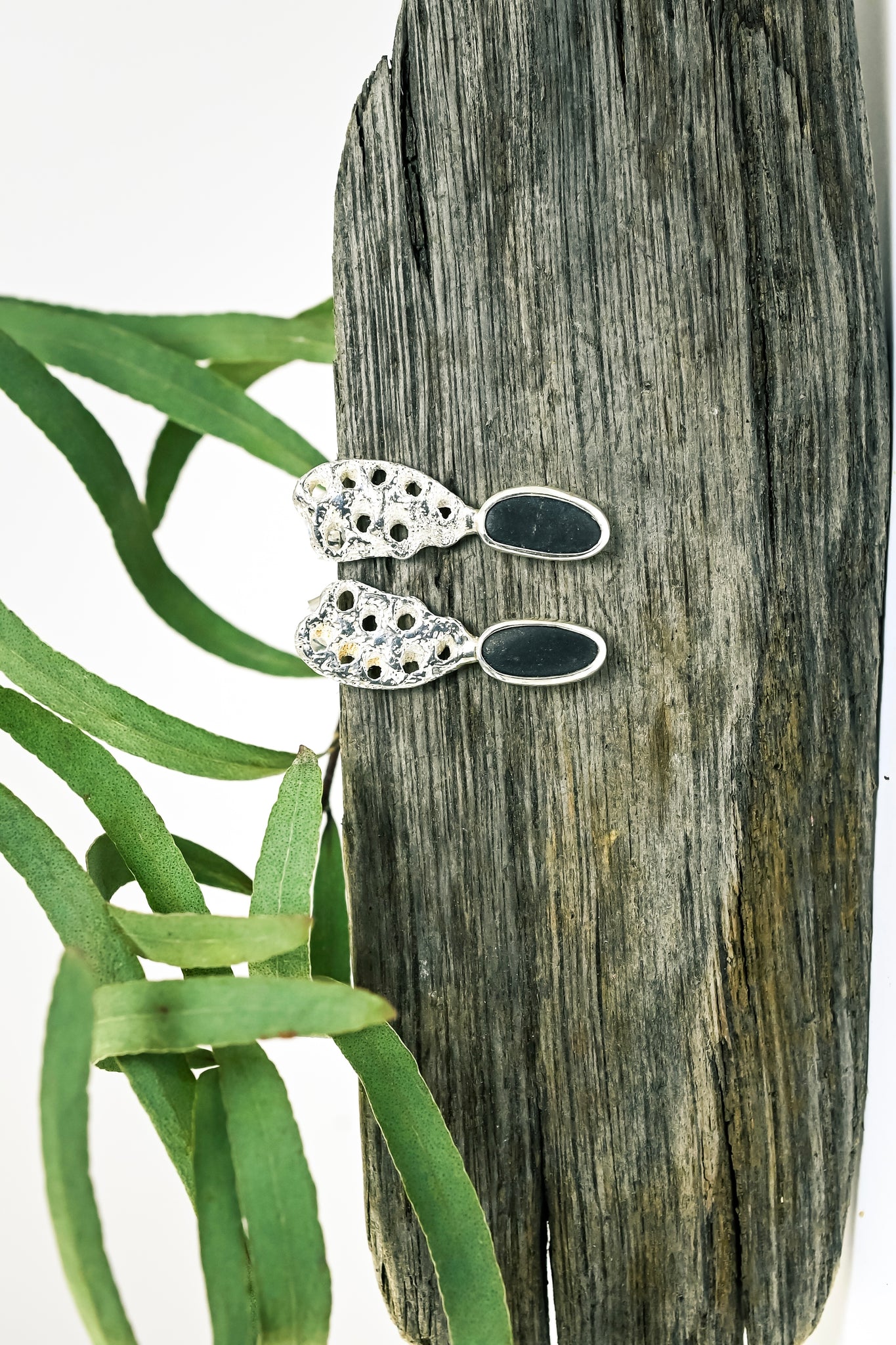 Silver earrings with rough seashore black stone. Handmade jewellery. 